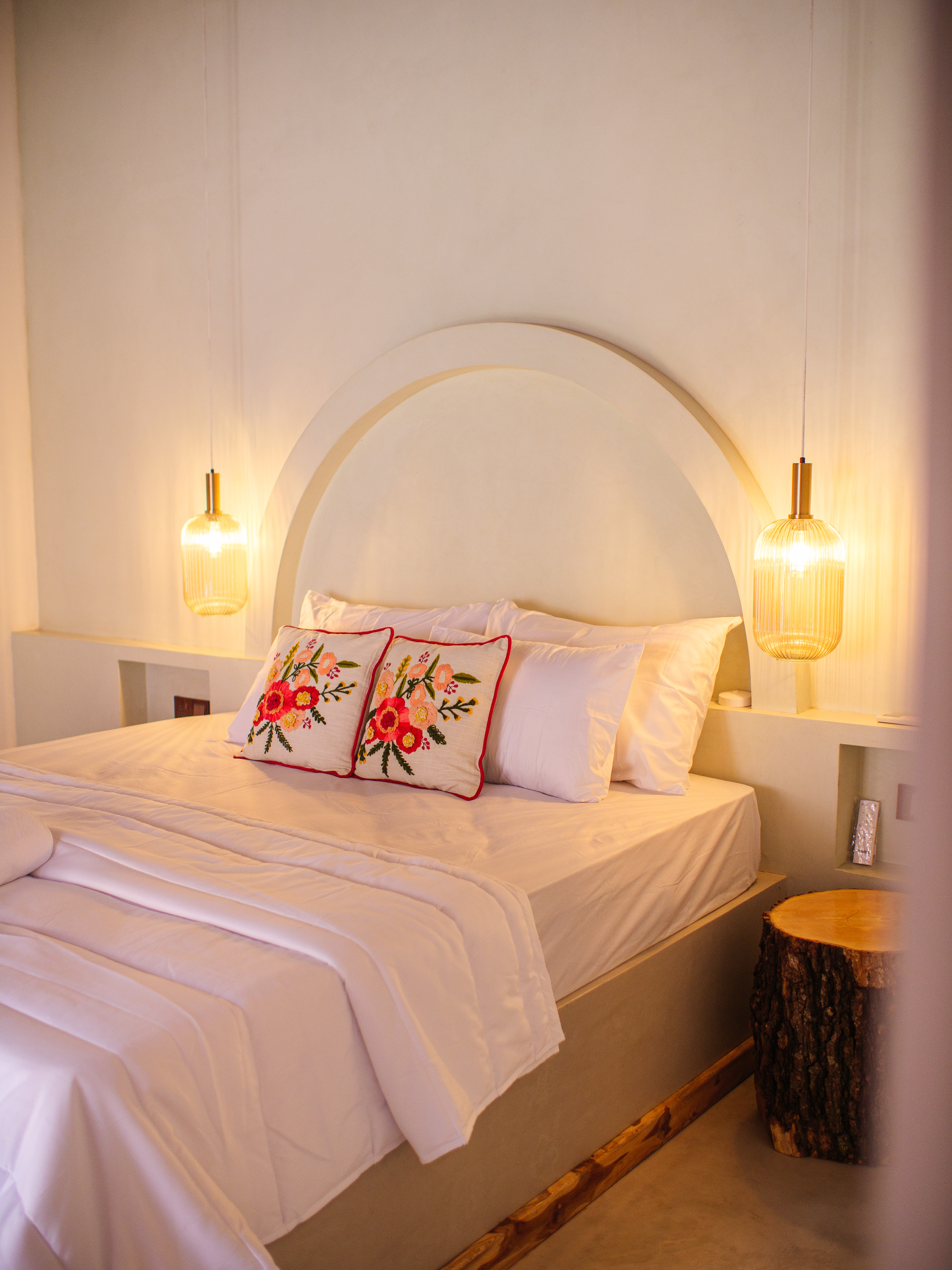 Cozy double room with embroidered cushions and queen bed — boutique stay in Arugam Bay